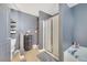 This bathroom includes a tub, shower, toilet, and storage shelves for a functional and efficient space at 5640 Silver Thistle Ln, St Cloud, FL 34772