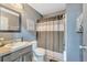 Stylish bathroom with a neutral striped shower curtain, vanity and modern finishes at 5640 Silver Thistle Ln, St Cloud, FL 34772