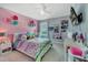 Cute bedroom with colorful decor, bright natural light, and a modern ceiling fan at 5640 Silver Thistle Ln, St Cloud, FL 34772