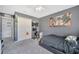 The bedroom features grey walls, a large window for natural light, and a cozy black bed at 5640 Silver Thistle Ln, St Cloud, FL 34772