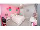 Pink bedroom featuring decorative wall accents, a ceiling fan, and plush carpet at 5640 Silver Thistle Ln, St Cloud, FL 34772