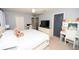 Bright primary bedroom with a plush bed, vanity, and neutral decor at 5640 Silver Thistle Ln, St Cloud, FL 34772