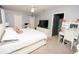 Bright primary bedroom with a plush bed, vanity, and neutral decor at 5640 Silver Thistle Ln, St Cloud, FL 34772
