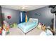 Bedroom features include a ceiling fan, plush carpet, and playful decor at 5640 Silver Thistle Ln, St Cloud, FL 34772