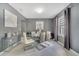 Elegant dining room with a glass table, modern chairs, stylish decor, and natural light from a window at 5640 Silver Thistle Ln, St Cloud, FL 34772