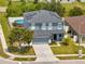Aerial view of home featuring solar panels on the roof, manicured lawn, and an above ground pool at 5640 Silver Thistle Ln, St Cloud, FL 34772