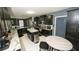 Modern kitchen featuring granite countertops, stainless steel appliances, and a center island at 5640 Silver Thistle Ln, St Cloud, FL 34772