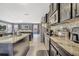 Modern kitchen with granite countertops, sleek appliances, and an open layout flowing into the living area at 5640 Silver Thistle Ln, St Cloud, FL 34772