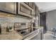 Close-up of a modern kitchen featuring stainless steel appliances and granite countertops at 5640 Silver Thistle Ln, St Cloud, FL 34772