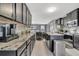 Modern kitchen with granite countertops, sleek cabinets, and stainless steel appliances at 5640 Silver Thistle Ln, St Cloud, FL 34772