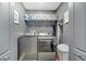 This laundry room features modern washer and dryer units with overhead storage and organized shelving at 5640 Silver Thistle Ln, St Cloud, FL 34772