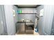 Convenient laundry room with modern washer and dryer, plus built-in shelving at 5640 Silver Thistle Ln, St Cloud, FL 34772