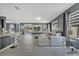 Open concept living room featuring tile flooring, a large TV, and a stylish white sofa at 5640 Silver Thistle Ln, St Cloud, FL 34772