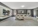 Bright living room featuring tile flooring, a large television, modern decor, and a stylish white sofa at 5640 Silver Thistle Ln, St Cloud, FL 34772