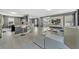 Spacious open concept living room featuring tile flooring, modern bar stools, and a large white sofa at 5640 Silver Thistle Ln, St Cloud, FL 34772