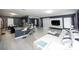 Open-concept living room boasts a modern design with sleek furniture and plenty of natural light at 5640 Silver Thistle Ln, St Cloud, FL 34772