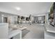 Open-concept living room boasts modern decor, kitchen island with seating, and elegant dining area at 5640 Silver Thistle Ln, St Cloud, FL 34772