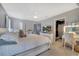 This main bedroom features a plush bed, dresser, vanity, and ensuite bathroom for a relaxing retreat at 5640 Silver Thistle Ln, St Cloud, FL 34772