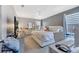 This main bedroom offers great natural light, stylish grey walls, and a comfortable and inviting atmosphere at 5640 Silver Thistle Ln, St Cloud, FL 34772