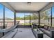 Screened-in patio with outdoor seating, hammock, and views of the backyard at 5640 Silver Thistle Ln, St Cloud, FL 34772