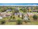 Bird's eye view of a home with a fenced yard, landscaping, and a storage shed at 707 Divot Ln, Poinciana, FL 34759