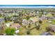 Aerial view of a residential neighborhood showcasing mature trees and well-maintained lawns at 707 Divot Ln, Poinciana, FL 34759