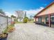 Spacious paved backyard with landscaping and a screened patio, offering outdoor living at 707 Divot Ln, Poinciana, FL 34759