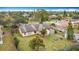 Aerial view of a home with a fenced yard, mature landscaping and grassy lawn at 707 Divot Ln, Poinciana, FL 34759