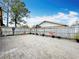 Large paved backyard with a wooden fence, offering ample space for outdoor activities at 707 Divot Ln, Poinciana, FL 34759