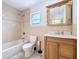Bathroom with a vanity, framed mirror, standard toilet and a tiled shower/tub combo at 707 Divot Ln, Poinciana, FL 34759