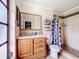 Cozy bathroom with a wood vanity and tiled shower/tub combo, offering a functional space at 707 Divot Ln, Poinciana, FL 34759
