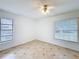 Bedroom with tile flooring, ceiling fan, and dual windows at 707 Divot Ln, Poinciana, FL 34759