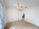 Bedroom with tile flooring, ceiling fan, and a view into the living area at 707 Divot Ln, Poinciana, FL 34759