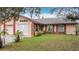 Attractive single-Gathering home boasts well-maintained landscaping and a welcoming entrance at 707 Divot Ln, Poinciana, FL 34759