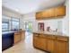 Open kitchen with breakfast bar, sleek appliances, and access to the patio through sliding glass doors at 707 Divot Ln, Poinciana, FL 34759