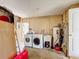 Spacious laundry room with a washer, dryer, utility sink and additional storage space at 707 Divot Ln, Poinciana, FL 34759
