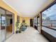 Enclosed patio featuring tile flooring and access to the backyard and kitchen, perfect for entertaining at 707 Divot Ln, Poinciana, FL 34759