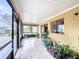 Enclosed patio featuring tile flooring and access to the backyard, ideal for indoor-outdoor living at 707 Divot Ln, Poinciana, FL 34759