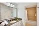 Bathroom featuring a granite countertop and a bathtub with a shower at 7602 Cabana Ct # 101, Reunion, FL 34747
