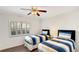 Bedroom featuring two beds, a ceiling fan, and a shuttered window at 7602 Cabana Ct # 101, Reunion, FL 34747