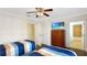Bedroom with twin beds, ceiling fan, TV on dresser and bathroom access at 7602 Cabana Ct # 101, Reunion, FL 34747
