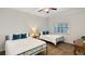 Bedroom featuring two beds, a ceiling fan, and a shuttered window at 7602 Cabana Ct # 101, Reunion, FL 34747