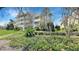 Exterior view of the building with multiple balconies, surrounded by mature trees at 7602 Cabana Ct # 101, Reunion, FL 34747