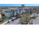 Exterior of the buildings, featuring beautiful landscaping, ample parking, and palm trees at 7602 Cabana Ct # 101, Reunion, FL 34747