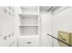 Well-organized walk-in closet with shelving, drawers, and space for hanging clothes at 7602 Cabana Ct # 101, Reunion, FL 34747