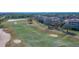 Aerial view of the lush green golf course, showing sand traps and walking path at 7602 Cabana Ct # 101, Reunion, FL 34747