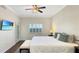 Bedroom featuring a ceiling fan, plantation shutters, and sliding door access to the exterior at 7602 Cabana Ct # 101, Reunion, FL 34747