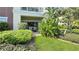 Cozy patio with table, chairs, and lush green landscaping at 7602 Cabana Ct # 101, Reunion, FL 34747