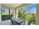 Comfortable outdoor patio with a table and chairs surrounded by lush greenery at 7602 Cabana Ct # 101, Reunion, FL 34747