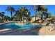 Resort-style pool with tropical landscaping, rock waterfall and various lounge areas at 7602 Cabana Ct # 101, Reunion, FL 34747